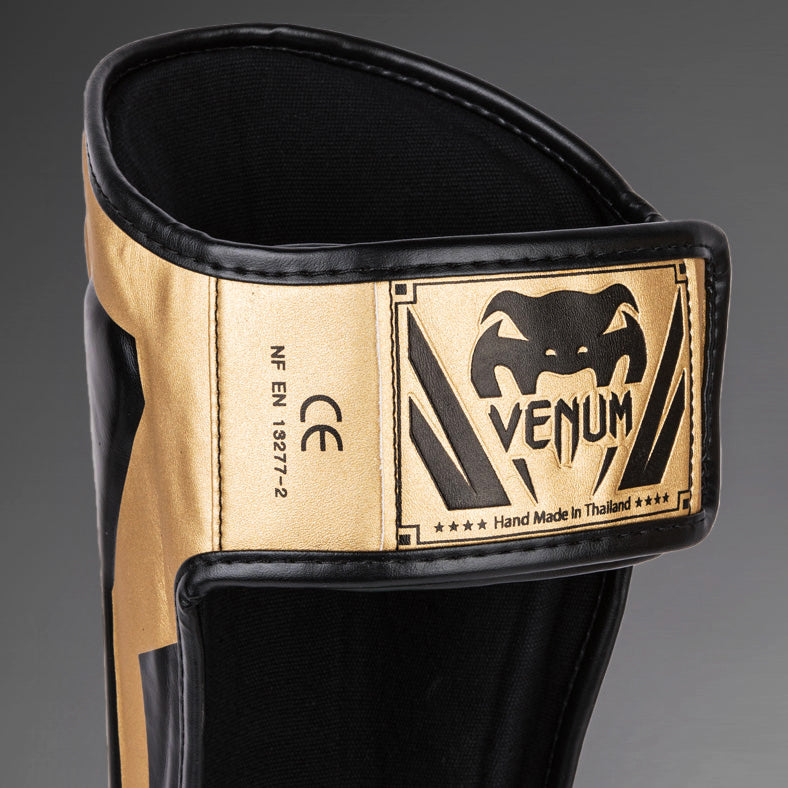 Venum Elite Espinilleras Standup - Oro/Negro