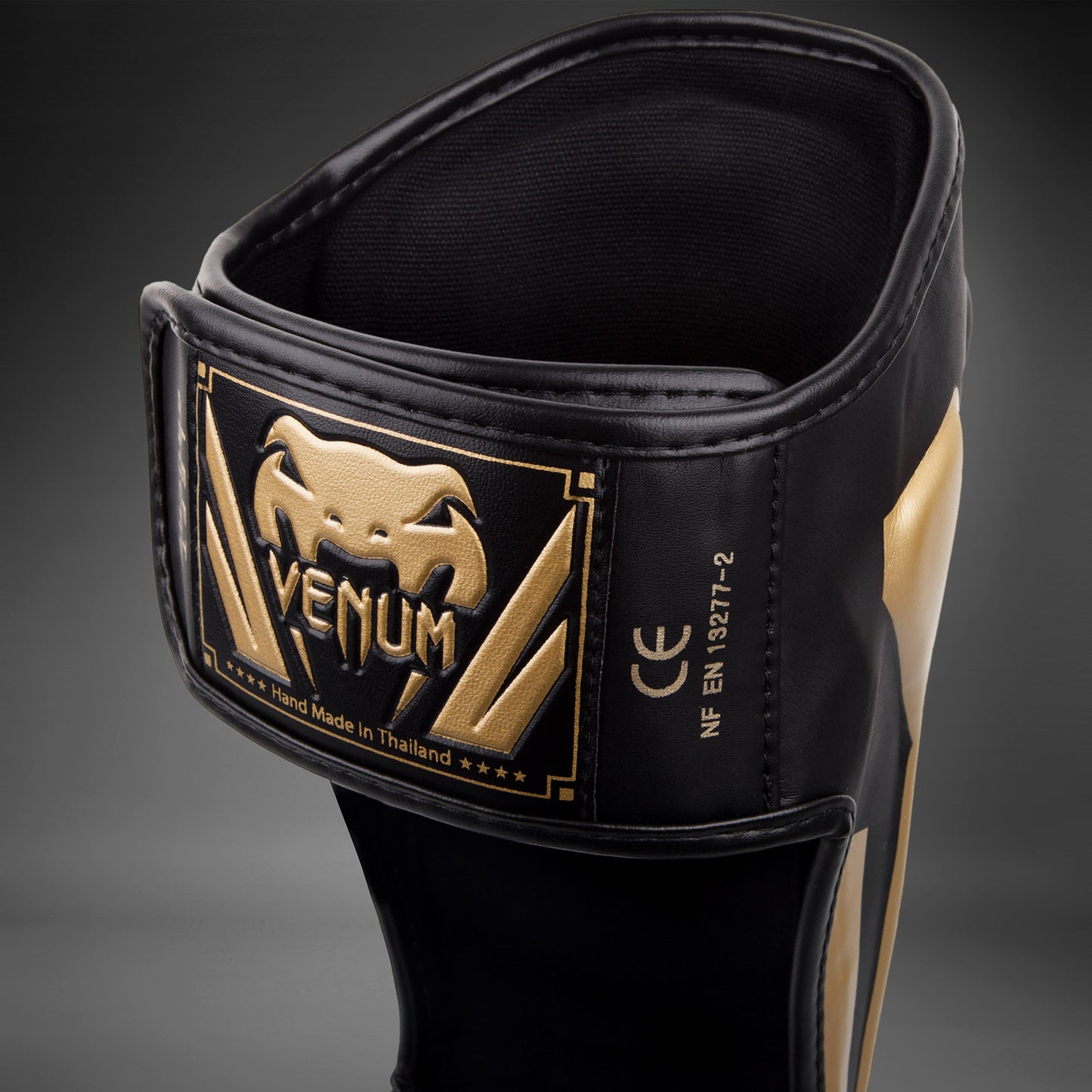 Espinilleras Venum Elite Standup - Negro/Oro