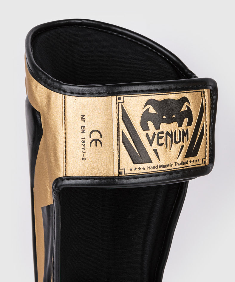 Venum Elite Espinilleras Standup - Oro/Negro