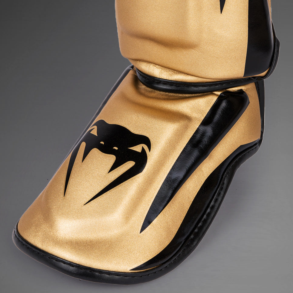 Venum Elite Espinilleras Standup - Oro/Negro
