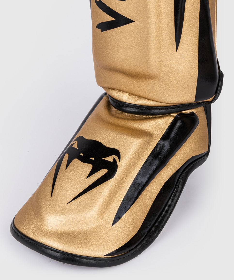 Venum Elite Espinilleras Standup - Oro/Negro