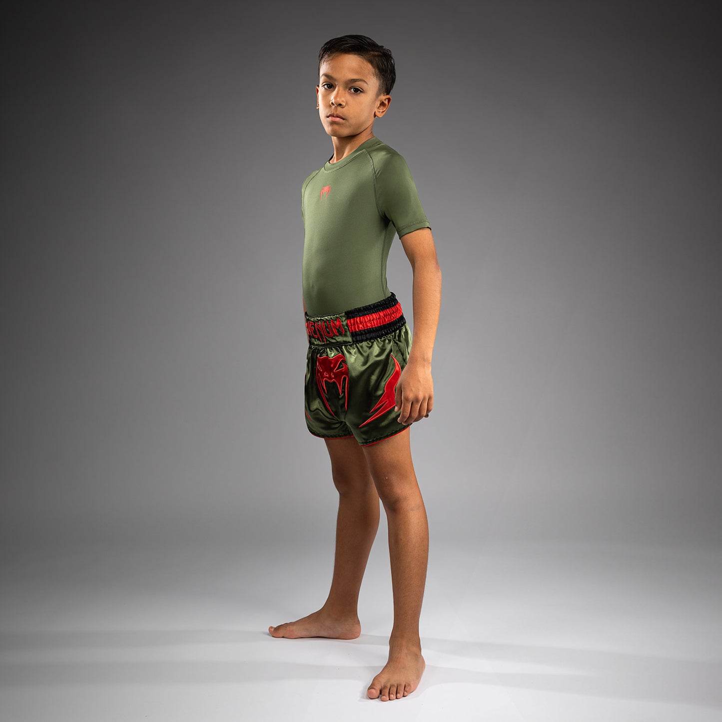 Venum Inferno Pantalones Cortos de Muay Thai para Niños - Verde Ejército/Naranja